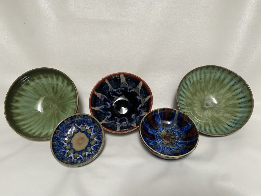 Various blue and green hand made bowls.