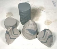 One lump of white clay and one lump of blue tinted porcelain, wedged together to create swirl patterns in the clay. 