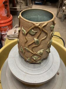 A stunning vase with a crawling vine design by Lesley